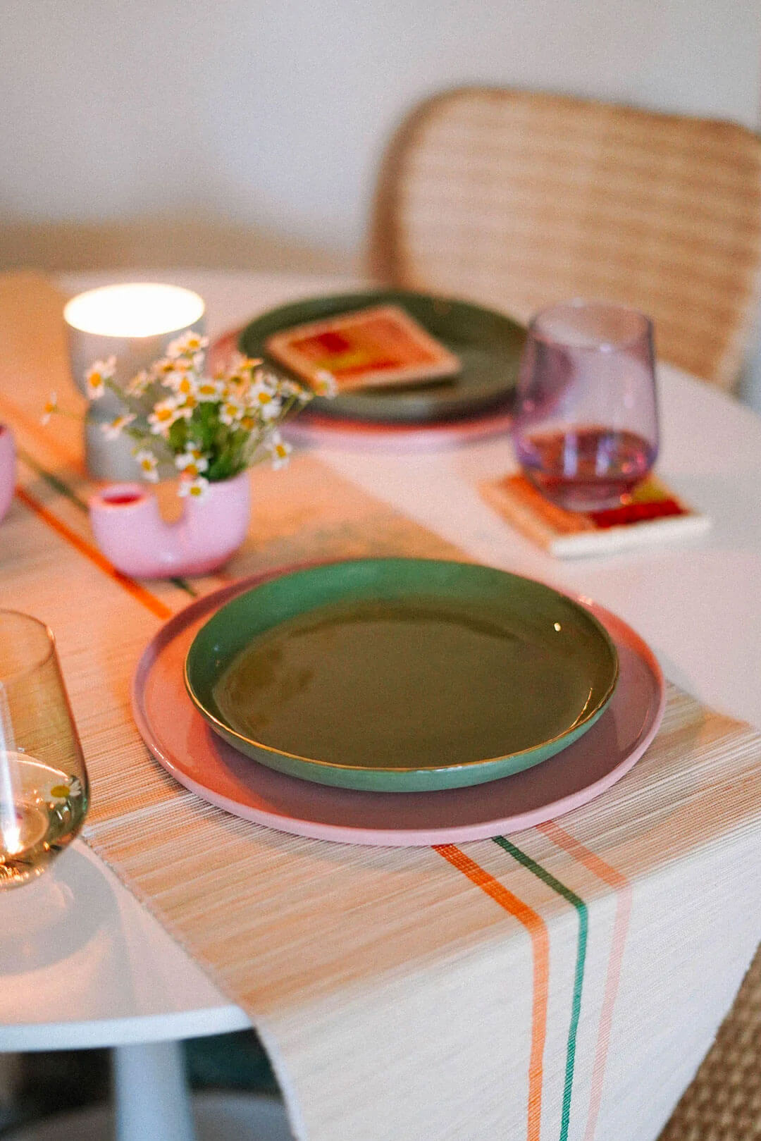 green and pink porcelain plates on maximalist taable