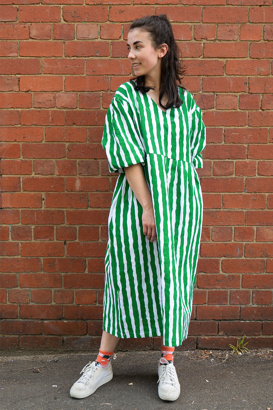 woman wearing green flowy striped dress