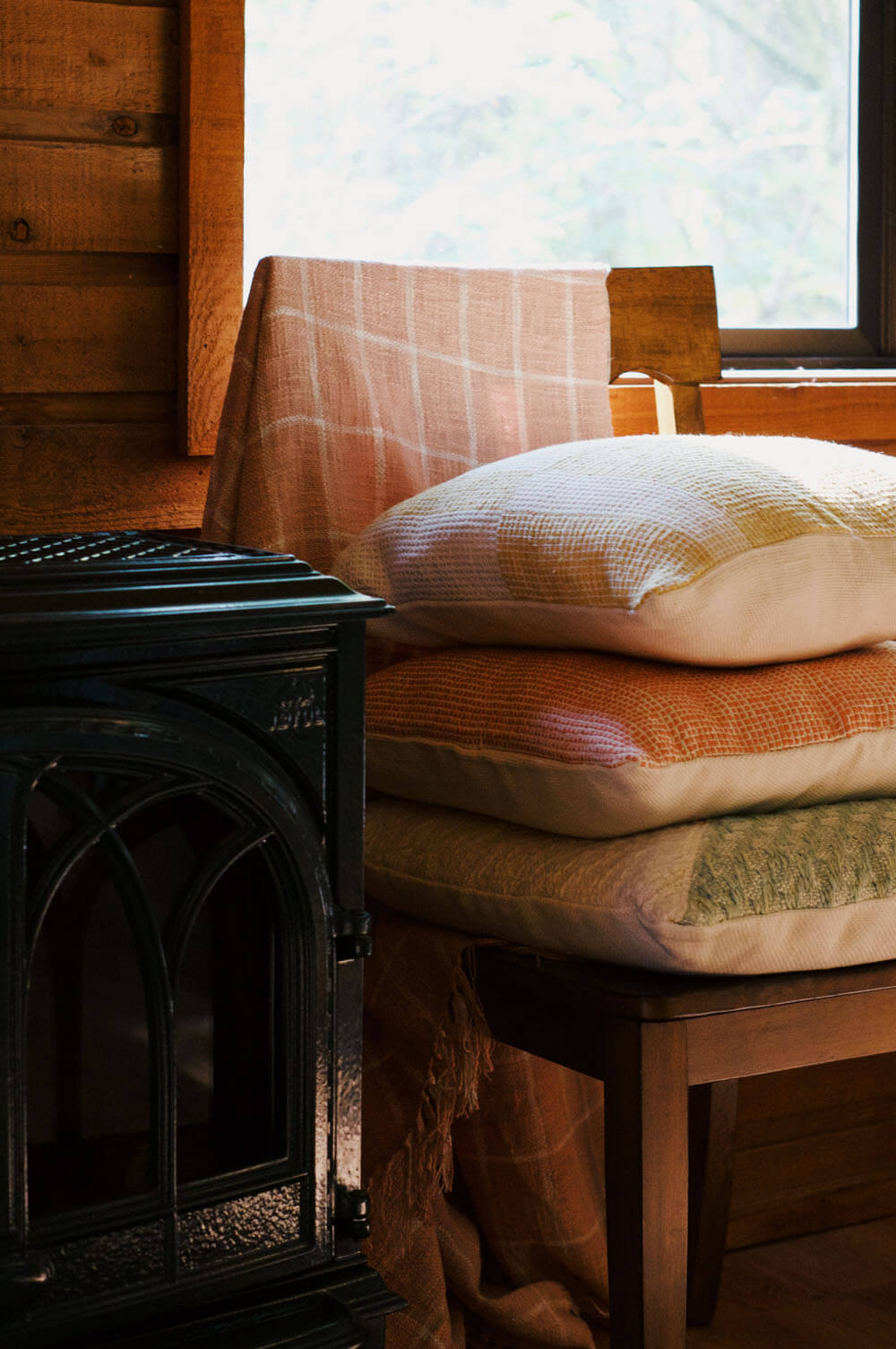 stack of handwoven pillows in cabin